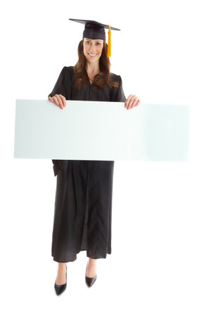Woman, graduation and poster with success in studio portrait with mock up space by white background. Person, university student and blank board for learning, education and celebration for achievementの写真素材