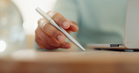 Hand, pen and thinking with person in home for distance education, learning or online study. Laptop, notebook and writing assignment with student in apartment for college or university scholarshipの写真素材