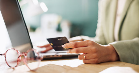 Credit card, hands and laptop with woman in office for company purchase, SaaS subscription or digital payment. Online banking, fintech and business budget with closeup of person for debit transactionの写真素材