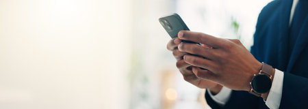 Hands, businessman and texting with phone in office of communication, schedule update and accountant. Person, mobile and reading corporate news, email feedback and financial report of investment chatの写真素材