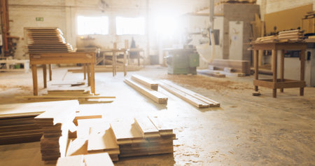Timber, wood and carpentry in empty workshop for furniture manufacturing, renovation and labor. Materials, plank and crafting production with woodwork, remodeling maintenance and restoration industryの写真素材