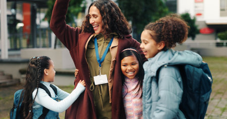 School kids, hug and smile with teacher, outdoor and reunion in city for solidarity, connection and playful. Children, group and woman with embrace, education and welcome for scholarship at academyの写真素材