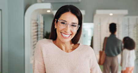 Optometry portrait, woman and happy with glasses in optical store for eye care, vision and designer frame. Mature person, customer and smile for eyewear shopping with lens choice, eyesight or fittingの写真素材