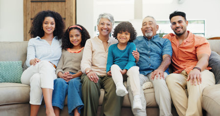 Happy, relax and portrait of big family on sofa in home for bonding, connection or quality time. Love, smile and children with parents and grandparents in living room for weekend together in house.の写真素材