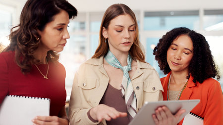 Business people, tablet and women in office, cooperation and internet with ad agency. Employees, group and sales consultant in workplace, tech and email with positive review, planning and digital appの写真素材