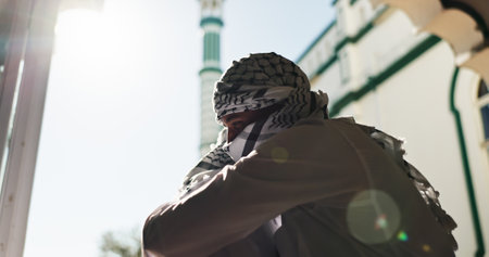 Friends, hug and Muslim people outdoor for greeting, hello and welcome to Mosque for religion. Islam, men and embrace together for culture, tradition and brotherhood with community on Eid Mubarakの写真素材
