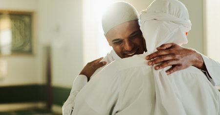 Muslim, religion and people in mosque, hug and happy for prayer in morning, belief and gratitude for God. Ramadan, embrace and men with Islamic faith in temple, worship and spiritual for Eid al Fitrの写真素材