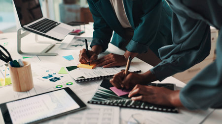 People, hands or writing with documents on sticky note for planning or brainstorming at office. Team, employees or group of designers with paperwork together for schedule agenda or ideas at workplaceの写真素材
