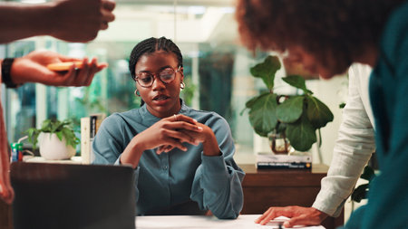 Collaboration, meeting and proposal with business people in office for ideas, pitch or planning. Brainstorming, laptop and listening with employee team in workplace for discussion or strategyの写真素材