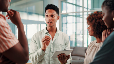 Tablet, team talking and business man with ideas, event planning and schedule in creative meeting. Technology, collaboration and group brainstorming in startup office, venue research and designの写真素材