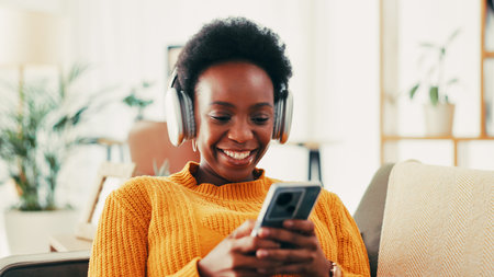 Home, sofa and black woman with smartphone for music, streaming online and podcast for motivation....