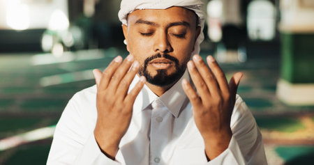 Islamic, man and hands in mosque for prayer, worship and gratitude to Allah for peace in morning. Muslim, male person and praise in temple for spiritual healing, mindfulness and faith in religionの写真素材