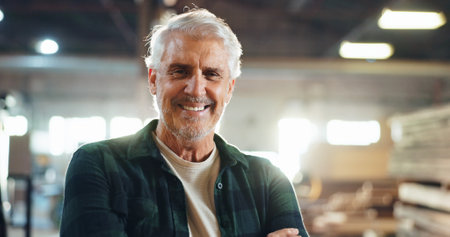 Carpenter, happy man and mature in portrait in workshop, wood manufacturing and production business. Warehouse, male person and contractor with smile for professional service, maintenance and craftの写真素材