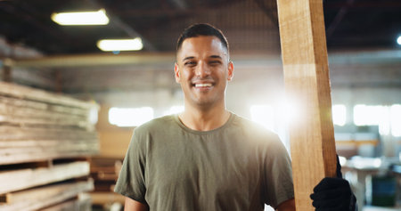 Workshop, man and portrait with smile for carpenter, wood manufacturing and production business. Warehouse, male person and contractor with happiness for professional service, maintenance and craftの写真素材