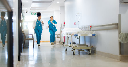 Doctor, nurse and running for hospital emergency with urgent healthcare, patient crisis and medical teamwork. Health team, clinic and rush in hallway for code blue, trauma service and quick surgeryの写真素材
