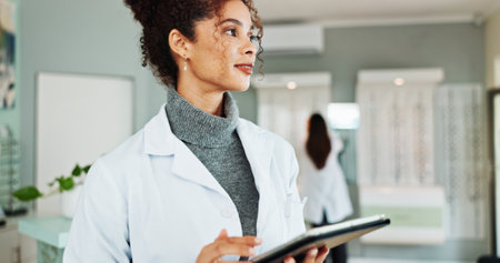 Tablet, thinking and optometrist in store for vision, eye care or wellness report online. Idea, research and female optician with digital technology for checking ophthalmology appointment in shop.の写真素材
