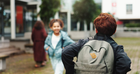 Back, student and walking with backpack outdoor for school, education journey and ready to learn. Academy, boy teenager and scholarship for academic development, knowledge study and growth on campusの写真素材