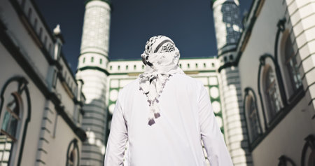 Islamic, man and mosque for faith, back and architecture for Muslim belief, outdoor and holy building. Structure, scenery and temple to worship Allah, spiritual and landmark for culture or personの写真素材