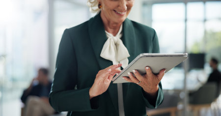 Hands, happy and tablet with business woman in office for administration, online planning or research. Report, review and smile with mature employee in professional workplace for email feedbackの写真素材