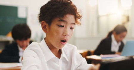 Education, child or wow in class with tablet, story development or quiz results in lesson. Japanese...