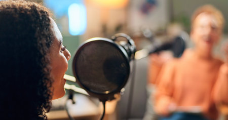 Woman, speaking and mic for podcast recording of talkshow, live streaming and hosting broadcast. Person, presenter or online discussion, content creator and radio news of information update in studioの写真素材