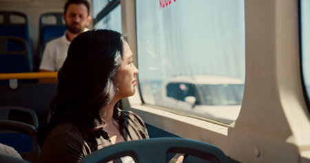 Window, thinking and travel with woman on bus for reflection, journey and adventure trip. Public transportation, vision and tourism with person in tram vehicle for passenger, commuter and destinationの写真素材