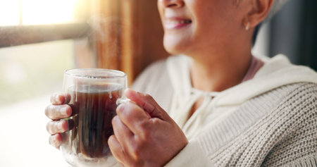 Home, hands and old woman with coffee, window view and morning routine with retirement. Apartment,...