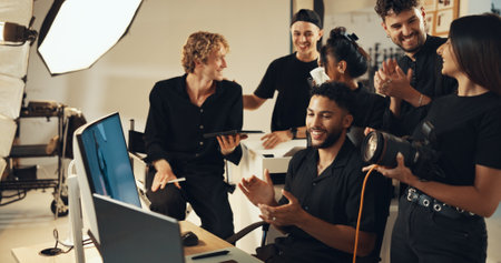 Happy people, studio or clapping for photography success for production results, project or review. Photographers, producer or computer to check for teamwork, magazine catalog or filming achievementの写真素材