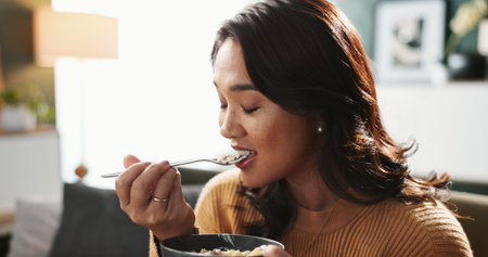 Home, woman and eating food on sofa for healthy meal, nutrition or enjoyment with eyes closed....