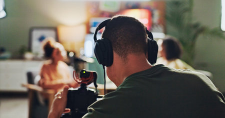 Content creation, podcast and streaming with director in studio for videography or live broadcast on air. Camera, interview and recording with people on production set for creative collaborationの写真素材