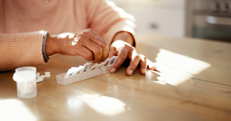 Senior, hands and pills container in home for prescription medication, tablets dosage or health management. Elderly person, medicine and capsule organzier for sorting drugs, daily routine or reminderの写真素材