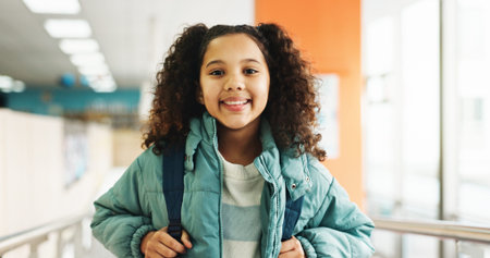 Happy girl, portrait and student with backpack at elementary school for growth, education or...