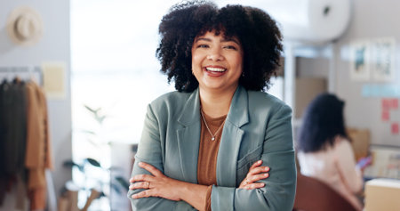Portrait, smile and woman with arms crossed, fashion company and designer with confidence. Face, happy person or entrepreneur with logistics, distribution and textile workshop with fabric and startupの写真素材
