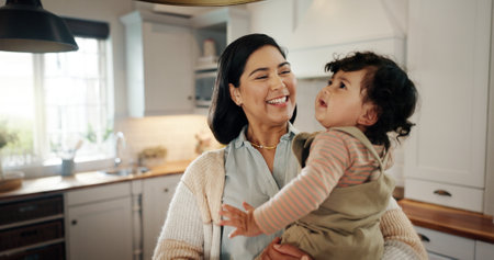 Home, hug and mother laughing with baby, smile and care for bonding together with love, parent or happiness. Relax, apartment or mom with growth, joy or infant with development, family or kid for funの写真素材