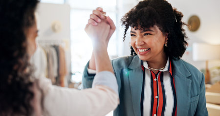 Fashion store people, happy and women with high five for small business celebration, startup growth or pride. Clothing boutique, employees or excited with shop success, teamwork or retail opportunityの写真素材