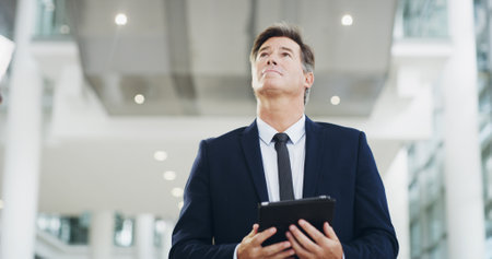 Business, tablet thinking with mature man in airport for international flight. Idea, planning and travel with corporate passenger at arrival or departure gate for global journey or transportationの写真素材
