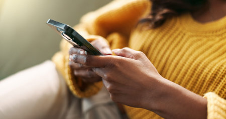 Hands, connection and phone in home for scroll, typing and text message on couch in living room....
