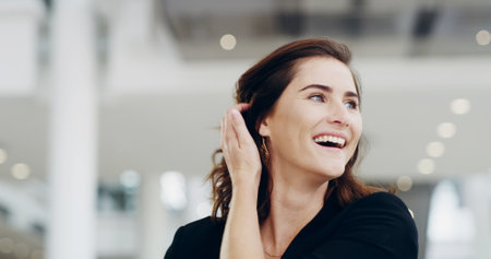 Airport, laughing and travel with business woman walking in terminal for international flight. Funny, future and planning with passenger at arrival or departure gate for journey or transportationの写真素材