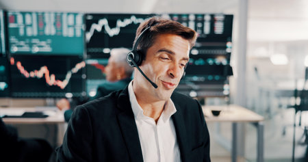 Broker, man or talking with headset in office for client portfolio management, investment advice or FAQ. Call center, stocks advisor and customer query for market insight, finance news and assistanceの写真素材