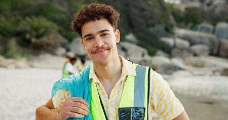 Cleaning, portrait and recycling with man on beach for community service or conservation. Charity,...