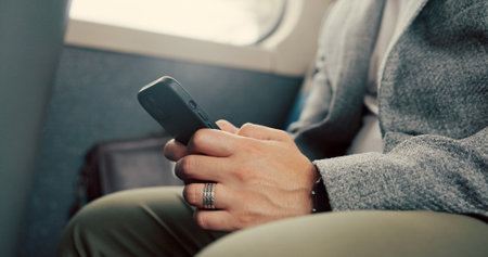 Hand, phone and texting in bus, travel and businessman with chat, search or typing email on commute. Person, smartphone and scroll with mobile application, contact or social media on public transportの写真素材