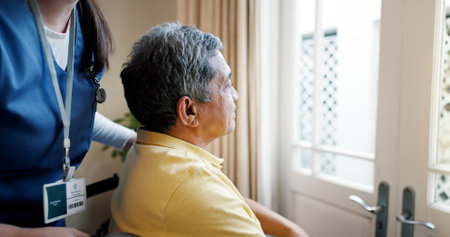 Memory, nurse and senior man by window for thinking, reflection or remember for dementia. Planning, ideas and elderly male patient in wheelchair with caregiver by glass door in assisted living.の写真素材