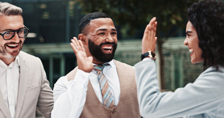 High five, business people and team outdoor to celebrate win, legal success or deal. Happy men, woman or excited lawyers together for friendship, partnership or gesture for promotion or growthの写真素材