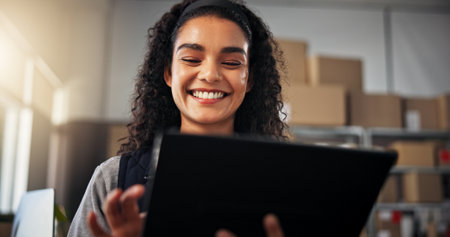 Smile, woman and tablet with boxes for delivery, online logistics and distribution in warehouse. Happy, person and digital information for ecommerce supply chain, package tracking and stock inventoryの写真素材