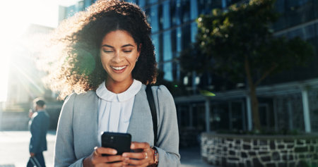 Happy, phone and professional with woman in city for legal policy update, news and lawyer case. Smile, reading and client litigation with person outdoor for mobile, networking app and advocateの写真素材
