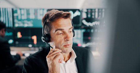 Broker, man and talking with headset by computer for investment advice, market insight and trading...