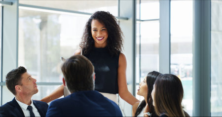 Business people, happy woman and meeting for pitch, presentation and collaboration in office. Smile, executive director and financial manager with budget proposal, review or teamwork for negotiationの写真素材