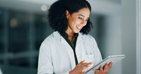 Research, science and woman with smile, tablet and internet with chemistry specialist. Person, scientist and expert in workplace, biotech and email with results, experiment and app with test reportの写真素材