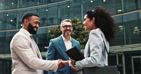 City, business people and smile with handshake for welcome, greeting and agreement for realtors. Urban, clients and real estate agent with shaking hands for introduction, deal success and partnershipの写真素材