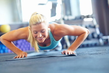 Woman, push ups and happiness for sports, exercise and fitness for workout with yoga mat or balance....
